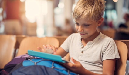 Child with tablet in airport