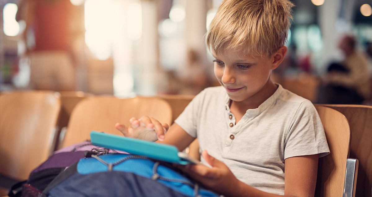 Child with tablet in airport