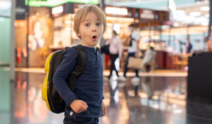 Child in airport looking amazed